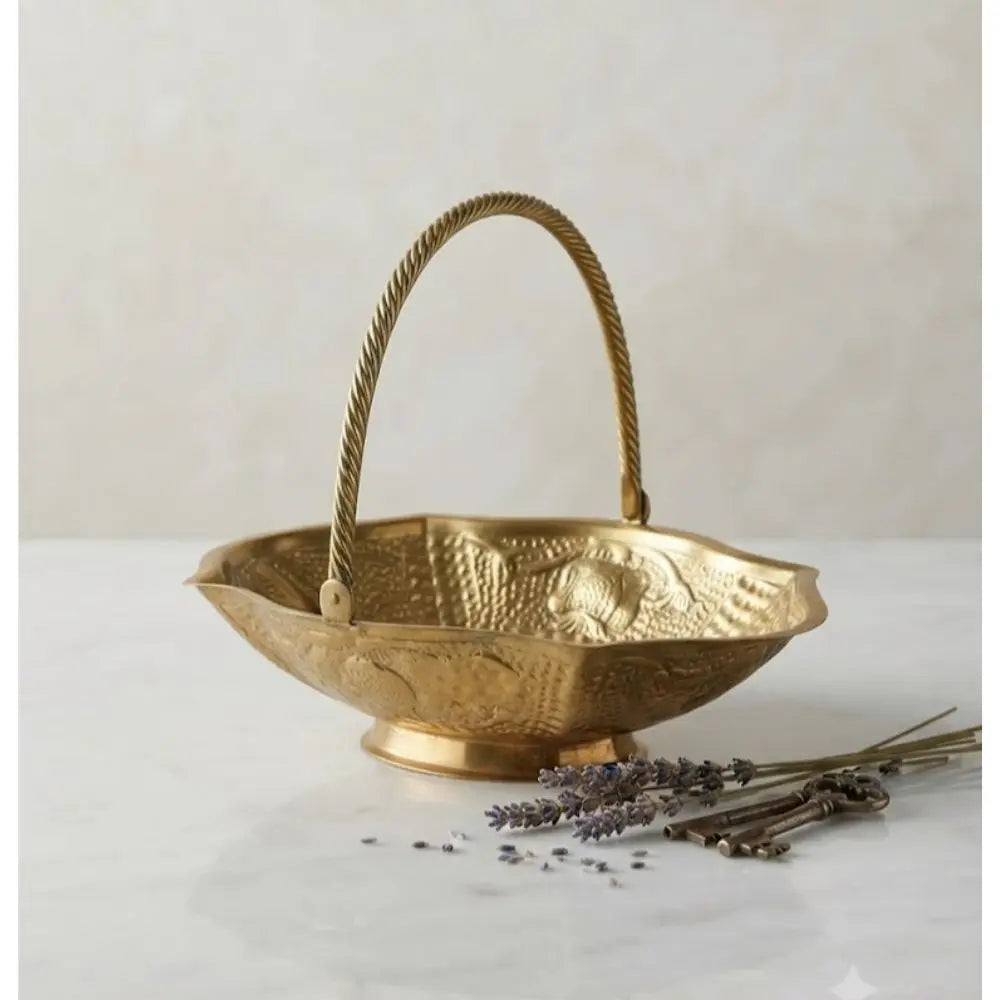 Hand-finished with delicate texture and a signature rope-twist handle, this brass basket celebrates the beauty of artisanal metalwork